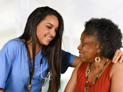 caregiver and elder woman looking at each other